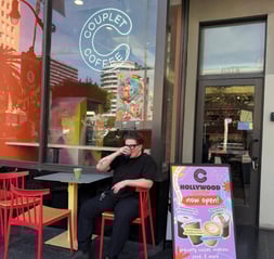 Interior of Couplet Coffee's fourth store at 6318 Hollywood Boulevard, an LGBTQ+ and women-led lifestyle brand, featuring ample seating, outlets, cozy vibe.