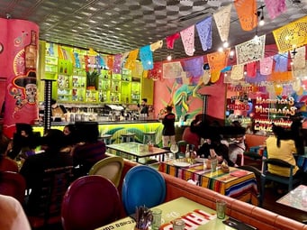 Lively restaurant interior with customers dining and festive decor, celebrating ProMeat’s partnership with the Impresario Entertainment & Hospitality Pvt. Ltd. Group and their launch of the signature Smoky Pepperoni at all Mezcalita outlets in Mumbai and Bangalore.