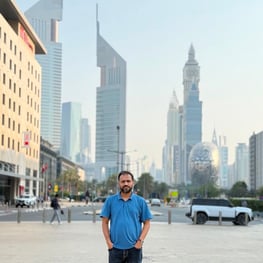 Shawon, Chhaya's founder standing on a street in Dubai, with high-rise towers and the Museum of the Future behind him, marking Chhaya's expansion into the UAE
