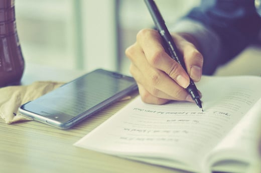 Person taking customer discovery notes