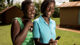 Two young women using their mobile phone